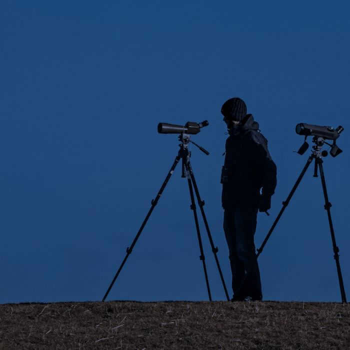 Man standing with two telescopes for astrophotography