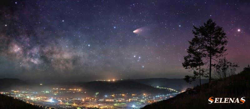 A comet over a nighttime city