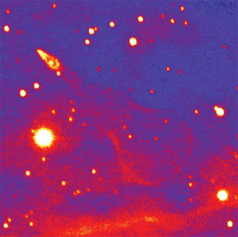 The Guitar Nebula is a shock wave diverging behind a neutron star (at the arrow) that is being carried through the gas at 1600 km/s. To give the star that speed, the explosion must be asymmetric.