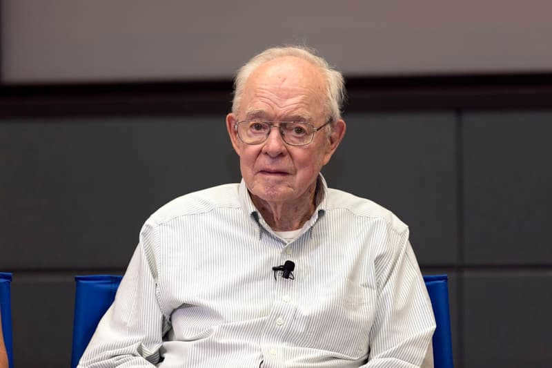 Pioneering heliophysicist astronomer Eugene Parker was the first to use the term "solar wind" (https://commons.wikimedia.org/wiki/File:Dr._Eugene_PKSC-20180809-PH_KLS02_0003arker_Speaks_to_Media_(30123740568).jpg)