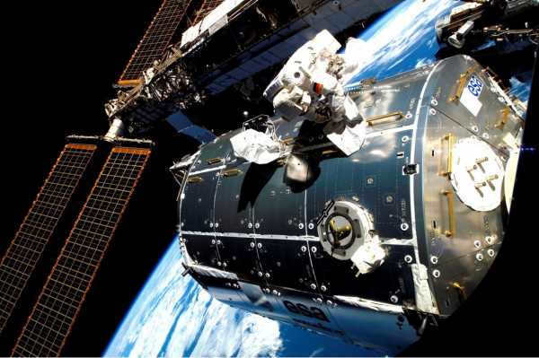 Astronaut Hans Schlegel working in open space