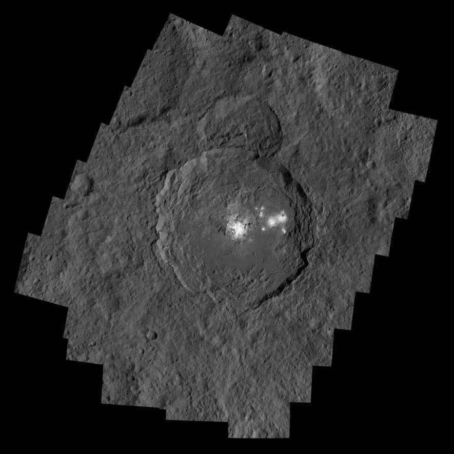 The Occrator crater is 92 kilometers in diameter and 4 kilometers deep. Inside it is the brightest region on Ceres. A close-up from the Dawn spacecraft shows the dome in the crater's smooth center. Linear formations and fractures stretch upward and diverge on the sides. There are also visible fractures centered around it, transitioning to brighter areas. The frame is made from two images created at a shorter exposure. It allows the details of the bright objects to be revealed. The photos were extracted by the LAMO camera at an altitude of 385 km above Ceres. The Jet Propulsion Laboratory is responsible for the Dawn mission. It is part of the more global Discovery project.