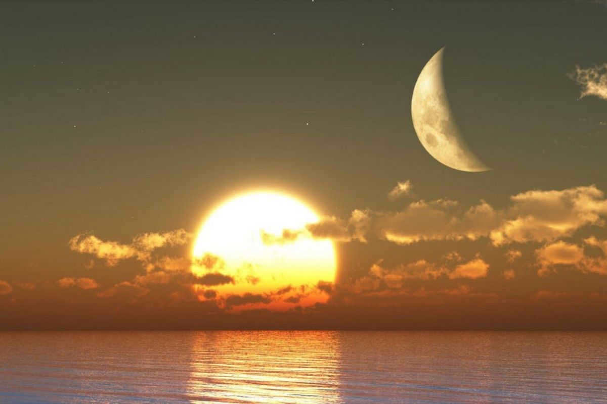 The moon and the sun in the sky at the same time