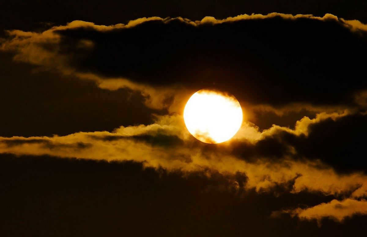 Sky with clouds Moon and Sun