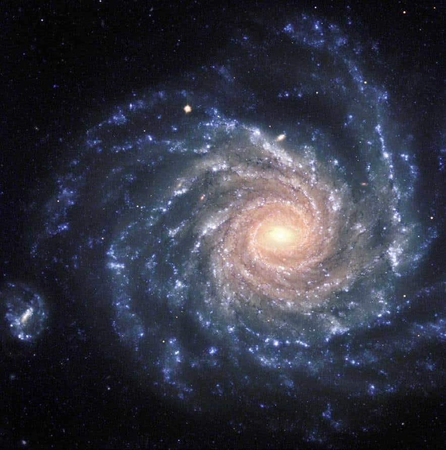 This is an amazing image of the large galaxy NGC 1232 taken on September 21, 1998. It consists of three exposures in ultraviolet, blue, and red light. The colors of the different regions are perfectly visible here: the central ones contain old red stars, and the spiral arms contain young blue stars. To the left is a distorted companion galaxy in the shape of the Greek letter "theta".