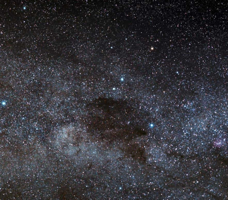 The Coal Sack Nebula is an opaque interstellar dust cloud that blocks out the light in the background of the Milky Way. Because of the absorption of the blue color, we see intense red stars in the northern and darkest part. The first European to see the nebula was Spanish navigator and discoverer Vicente Yañez Pinson when he sailed to the coast in 1499. He named it the "Black Magellanic Cloud." The Incas believed that the god Ataguchu sent a bolt of lightning into the Milky Way in anger, detaching the Small Magellanic Cloud. And in the empty space, this nebula was formed.