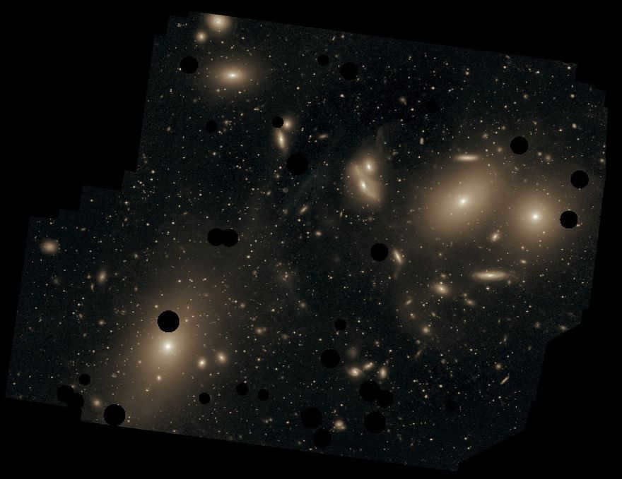 This deep image of the cluster shows the scattered light between galaxies. Dark spots indicate where bright front stars have been removed. Messier 87 is the largest galaxy in the image (bottom left).