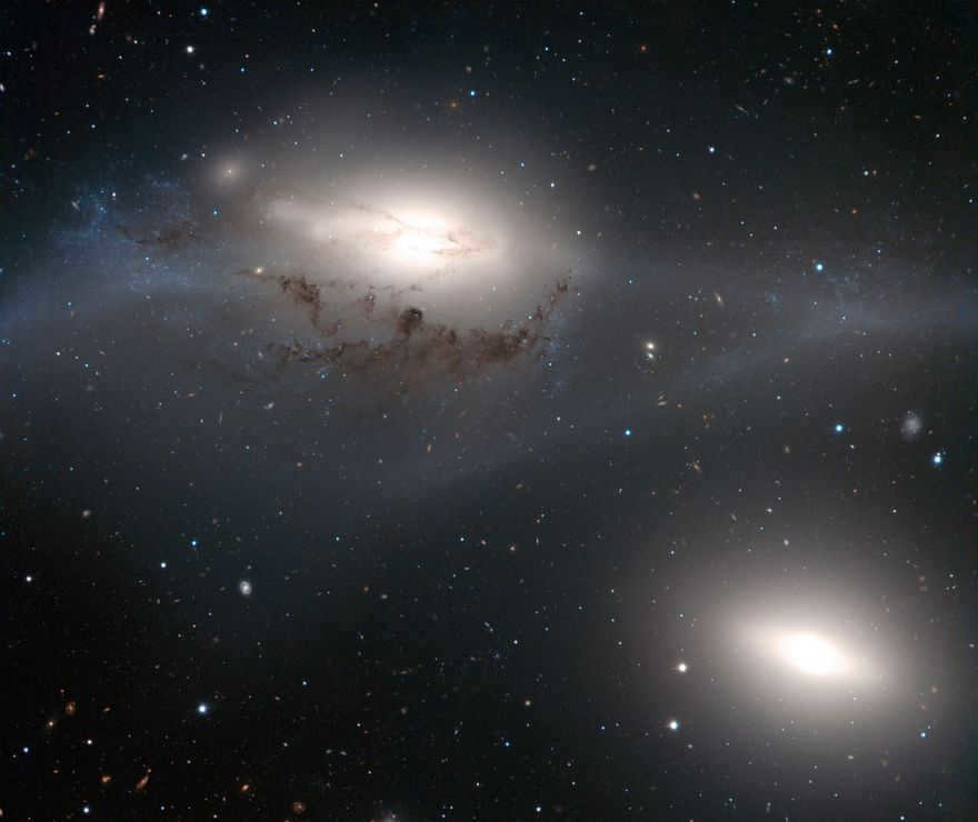 In front of you is a beautiful but peculiar galactic pair, NGC 4438 and NGC 4435, nicknamed the Eyes. The larger NGC 4438 (top) was once a spiral galaxy that deformed after collisions with other galaxies.