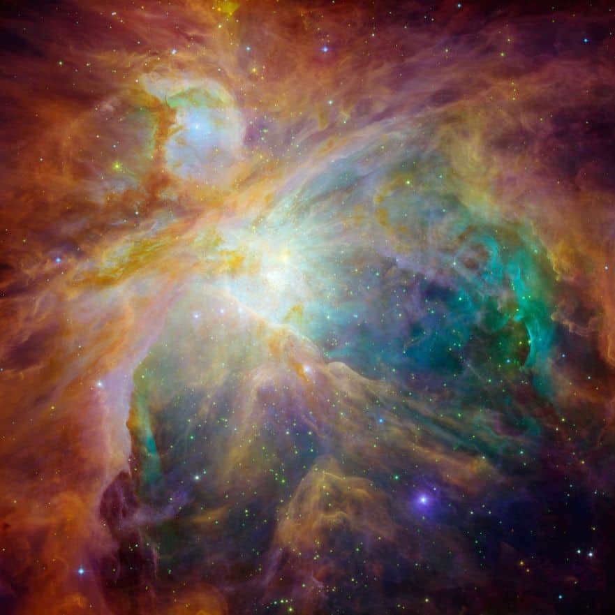 In the bright image taken by infrared observation and visible, it is noticeable that the 4 massive central stars (yellow spot near the center) are responsible for the glow. The green swirls (Hubble Ultraviolet light) display hydrogen and sulfur gas heated by radiation from the Trapezium stars. And here Spitzer discovers carbon-rich molecules (shown in red and orange). On Earth, such molecules (polycyclic aromatic hydrocarbons) are found in automobile exhaust. Both telescopes show the nebula as a stellar rainbow. The orange and yellow ones are baby stars hidden in dust cocoons. The more open and dust-free ones are green, and the blue ones are foreground stars. The large depression on the right could have been created by the winds of the Trapezium stars.