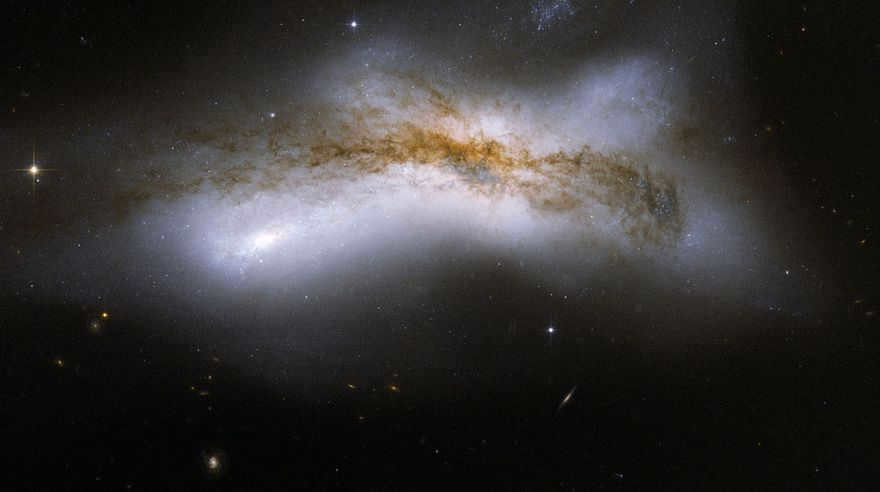NGC 520 is the result of two disk galaxies colliding 300 million years ago. In the image you see the middle stage of the merger process: the disks have merged, but the nucleus has not yet. You can also see a strange stellar tail and a dust trail stretching diagonally across the center, covering the galaxy. This is one of the brightest galaxy pairs that can be observed in a small telescope. They're 100,000 light-years across. They have the designation Arp 157.