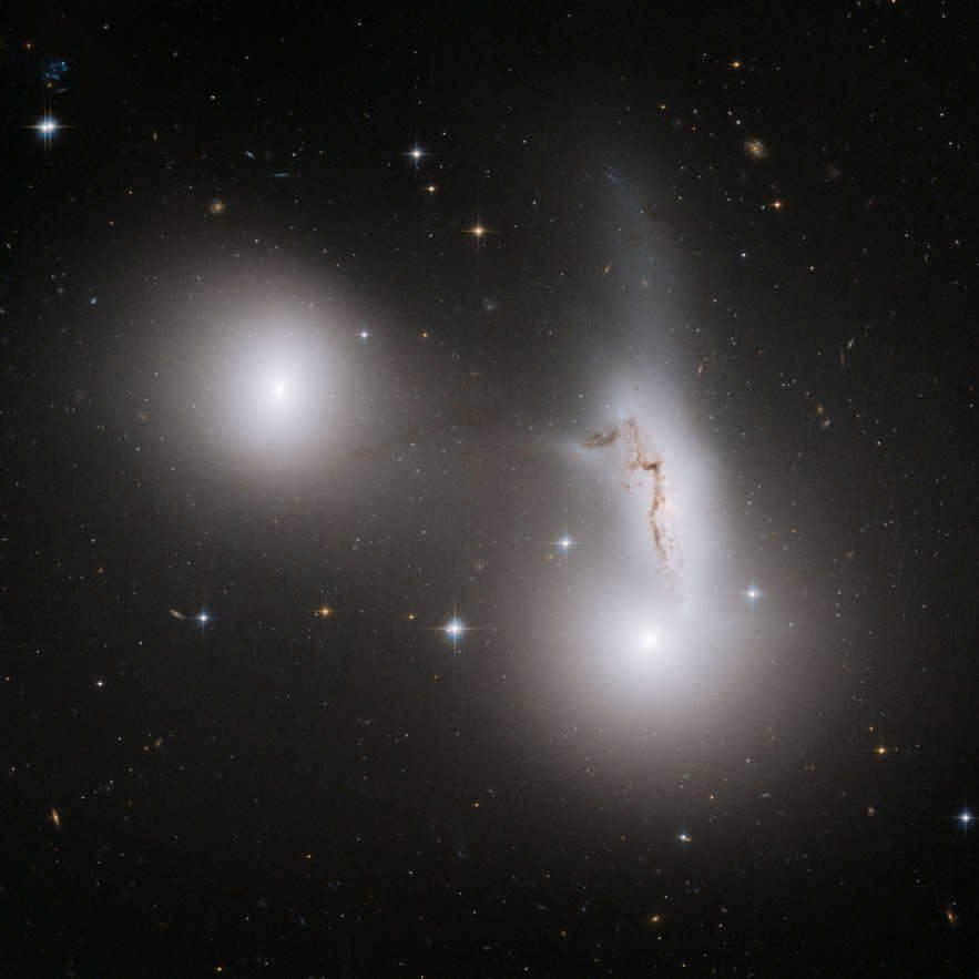 NGC 7173 (middle left), NGC 7174 (center right), and NGC 7176 (bottom right) are part of the Hickson Compact Group, named after astronomer Paul Hickson. He was the first to record these small galaxy clusters in the 1980s. NGC 7173 and NGC 7176 look like smooth elliptical galaxies without too much gas or dust. NGC 7174, on the other hand, is a distorted spiral galaxy being torn apart by its nearest neighbors. The strong tidal interaction blasting through galaxies has dragged a significant number of stars from their home galaxies. They are now scattered, creating a faint luminous component.