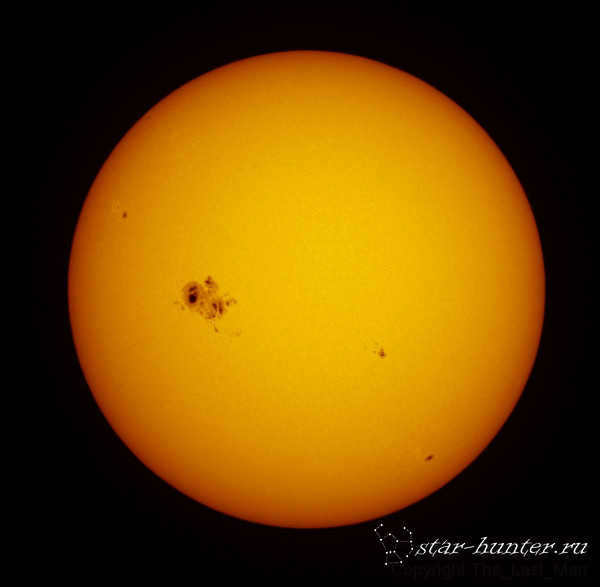 Sun with spots when viewed through a telescope with an aperture solar filter