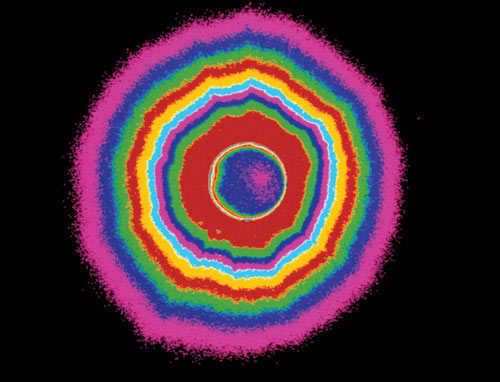 Solar corona. A photograph of the solar corona (in synthetic colors, the blue with pink spot in the center is the Moon) taken during a total solar eclipse on February 26, 1998. The corona is the outer part of the solar atmosphere, consisting of rarefied hydrogen heated to temperatures on the order of a million degrees Celsius. Popular Mechanics image