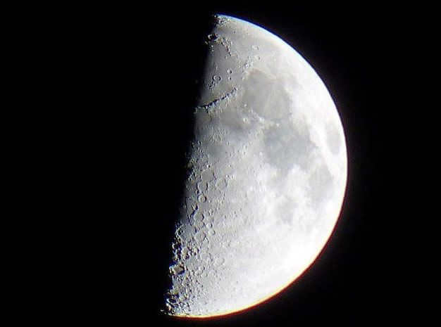 View of the Moon through the most ordinary 10x50 "hunting" binoculars.
