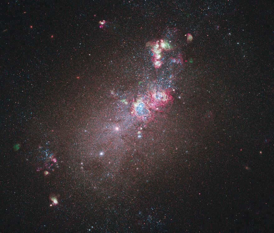 Galaxy NGC 4214. Notable is the huge glowing cloud of hydrogen gas, the place where new stars are born. Massive young stars are located in a heart-shaped cavity. Their temperatures reach 10000-50000 °C.