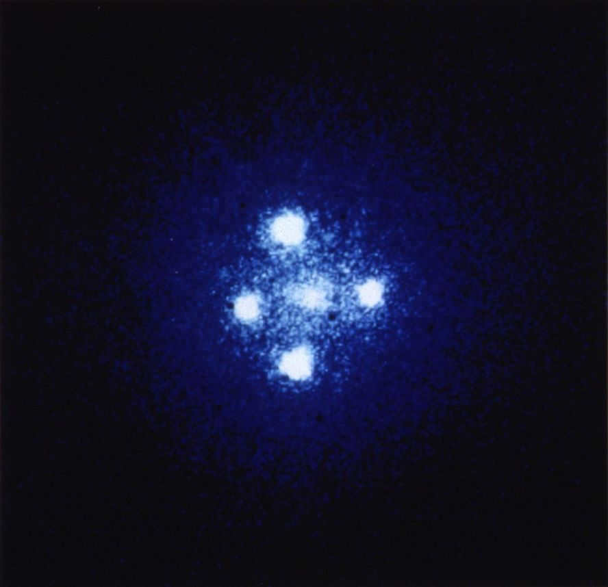 Maximum detail image taken by the gravitational lens G2237+0305 (Einstein's Cross). Here we see 4 images of a very distant quasar that has been magnified many times by a relatively close galaxy acting as a gravitational lens. The angular distance between the top and bottom images is 1.6 angular seconds.
