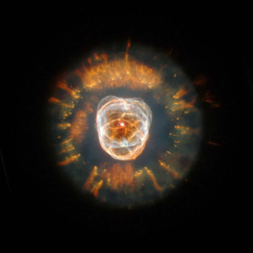 The Eskimo Nebula (NGC 2392), imaged in December 1999 by the Hubble telescope. It is called the "Eskimo" because when observed through ground-based telescopes, it appears to have a face surrounded by a fur parka in front of you.