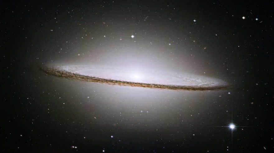 The Sombrero Galaxy (M104) in Virgo is one of the greatest galaxies at the edge of the sky, and most people say it looks like a flying saucer. It consists of a large spinning disk with a bulging band of dust engulfed in a glowing halo of gas and stars. It is 43 million light-years away and about half the size of the Milky Way, with a diameter of 49,000 light-years (Photo: NASA and the Hubble Legacy Team (AURA / STScI))