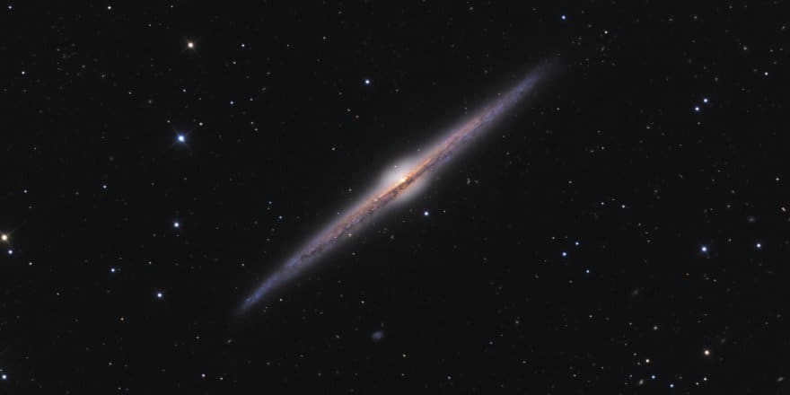 NGC 4565 or the Needle Galaxy in the Coma Cluster is the brightest and best known galaxy in our sky, perfectly oriented at the edge of line of sight. We can observe its disk as a thin silvery needle. At a distance of about 57 million light-years, it is in the Virgo cluster, and it has a prominent central bulge, suggesting that it may be a spiral band.