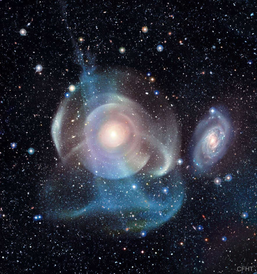 The mysteriously distorted elliptical galaxy NGC 474 in the constellation Pisces is 100 million light-years away. The neighboring spiral galaxy NGC 470 lies directly above it. Multiple shells and tidal tails surround NGC 474, caused by interactions with neighbors and density waves that propagate through the medium. This giant object spans 250,000 light-years and is two and a half times the diameter of the Milky Way (photo: P-A. DUC (CEA, CFHT), ATLAS 3D Collaboration)
