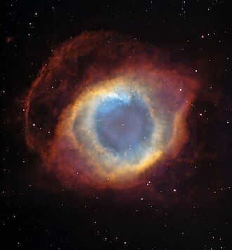 A colorful shell that looks like an eye. It shows a small central star with a blue circular area in the center, which may represent the iris. It is surrounded by an iris of concentric orange stripes. It is surrounded by a red eyelid-shaped area in front of the edge where a simple space is shown. Background stars dot the entire image.