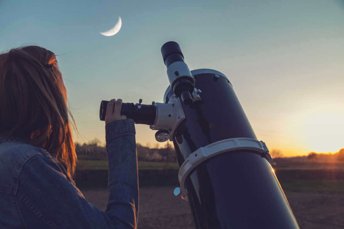 A girl looks up at the evening sky