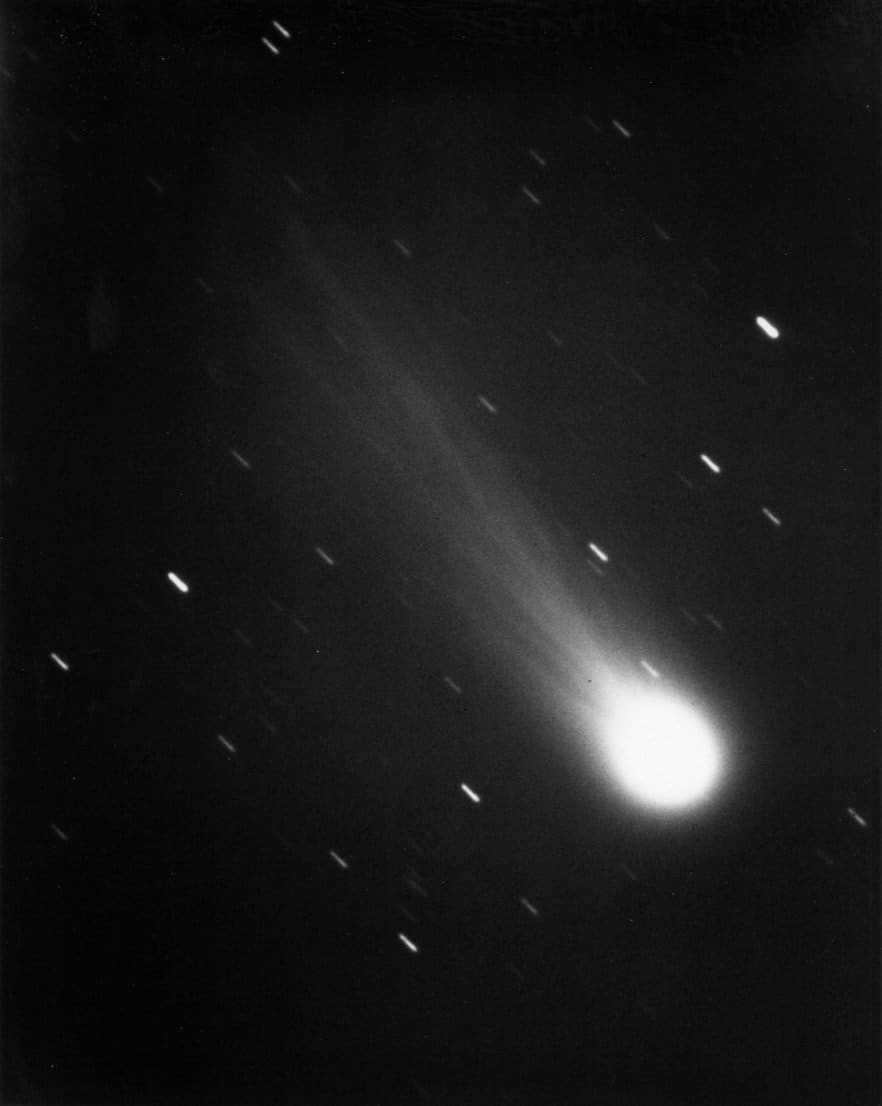 On January 13, 1986, James Young recorded Halley's Comet from Table Mountain Observatory using a 24-inch reflecting telescope. The bands created in the exposure are stars in the territory of Aquarius. The coma and the charged ion tail stretched for 725000 km stands out in the image.