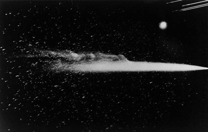 On May 13, 1910 the image of the comet was extracted on a wide-angle camera of Lowell Observatory. A line is visible near the coma - a meteor trail. The lines at lower right are the lights of the city of Flagstaff, and the bright spot above it is Venus.