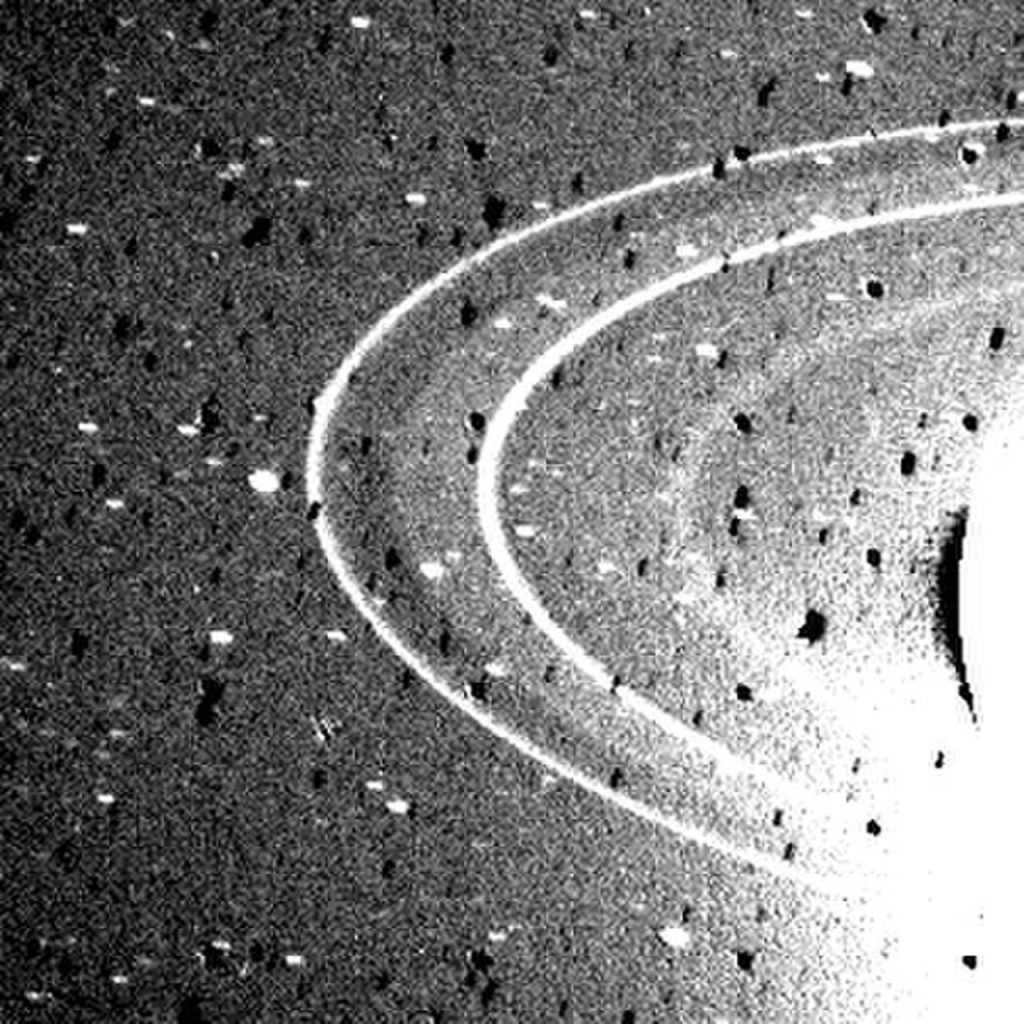 This photograph of Neptune's rings was obtained by Voyager 2 on August 26, 1989, using a wide-angle camera with an exposure of 591 seconds. Clearly visible are the two main thin and bright rings 1989 N2R Leverier in the center and 1989 N4R Arago to the left