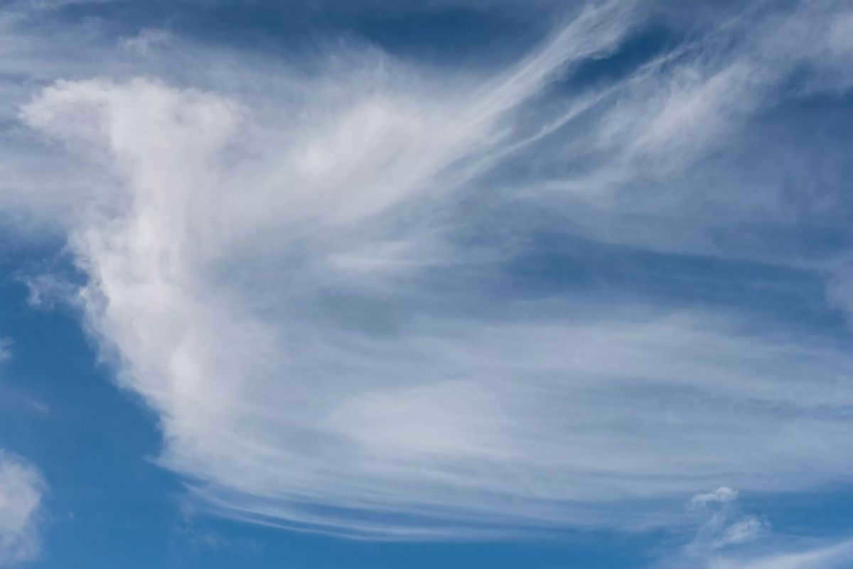 Thin puffy clouds high in the blue sky