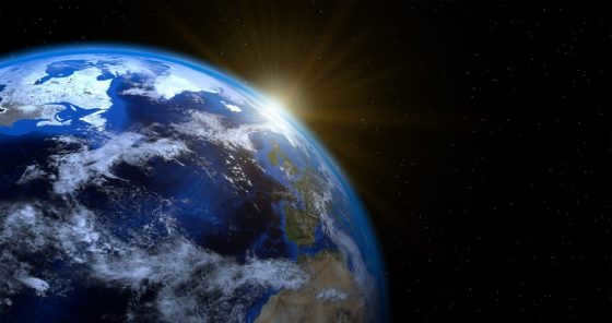 Why does the Earth revolve around the Sun and spin on its axis?