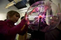 Children play with a plasma ball at the Experimentarium museum of entertaining sciences in Moscow.