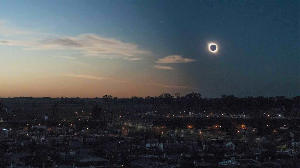 Solar eclipse over a city