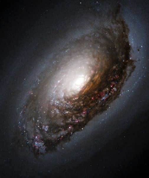 M 64 (Sleeping Beauty Galaxy, Black Eye Galaxy) is a galaxy in the constellation Veronica's Hair. The peculiarity of this object is its origin from two merged galaxies with different rotation directions. As a consequence, the gas-dust disk in the inner part of the object rotates in the opposite direction to the rotation of stars and gas at its periphery.