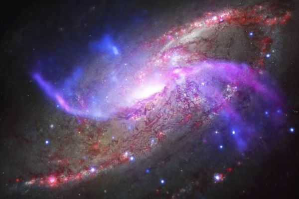 This colorful spiral galaxy is known as NGC 4258. Its shape is very similar to our Milky Way, although it differs in the presence of two additional spiral arms. Scientists noted that the ejection of gas from the disk has fatal consequences for the fate of this galaxy. Researchers have calculated that all the remaining gas the galaxy will eject in the next 300 million years, which is very soon in cosmic time scales. This is because the supermassive black hole at the center of NGC 4258, which is about ten times larger than the Milky Way, uses gas at a higher rate. 
