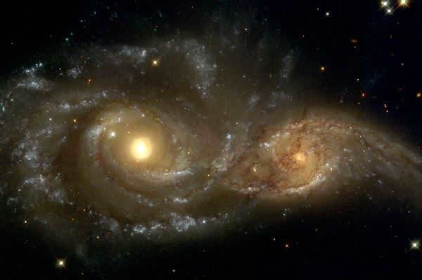 NGC 2207 is a spiral galaxy with a junction in the constellation Big Dog. It was discovered by John Herschel in 1835 along with neighboring galaxy IC 2163. The pair of galaxies are actively interacting, being at the beginning of the merger process. The galaxy is about 36 Mpc away from Earth. The merger with the neighboring galaxy is in its initial phase, the spiral structure of both galaxies is still intact, but the process will result in an elliptical or lenticular galaxy in about a billion years. 