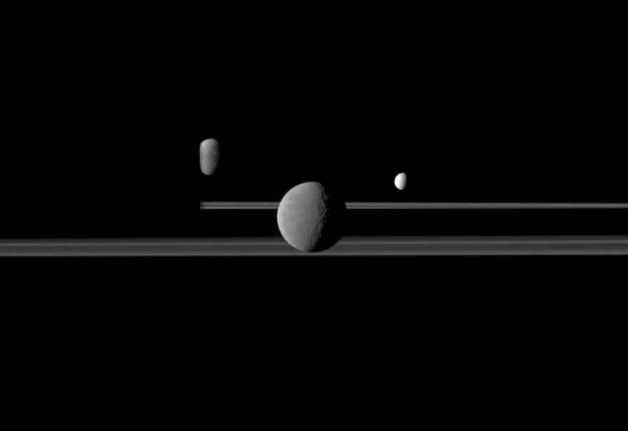 Cassini observes three of Saturn's satellites against the planet's dark side